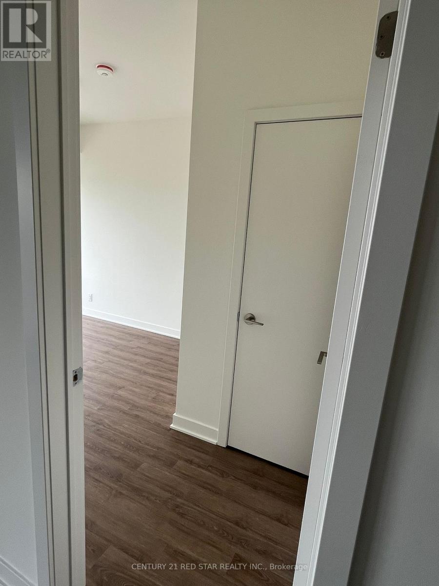 A white door is in a room with wood flooring.