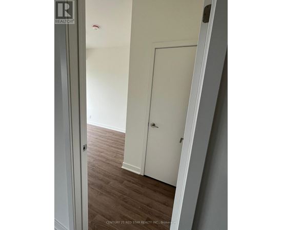 A white door is in a room with wood flooring.