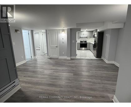 A spacious kitchen with a refrigerator, oven, and sink is visible in the image.