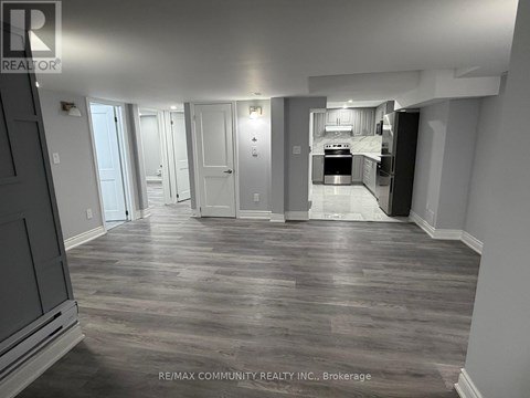 A spacious kitchen with a refrigerator, oven, and sink is visible in the image.