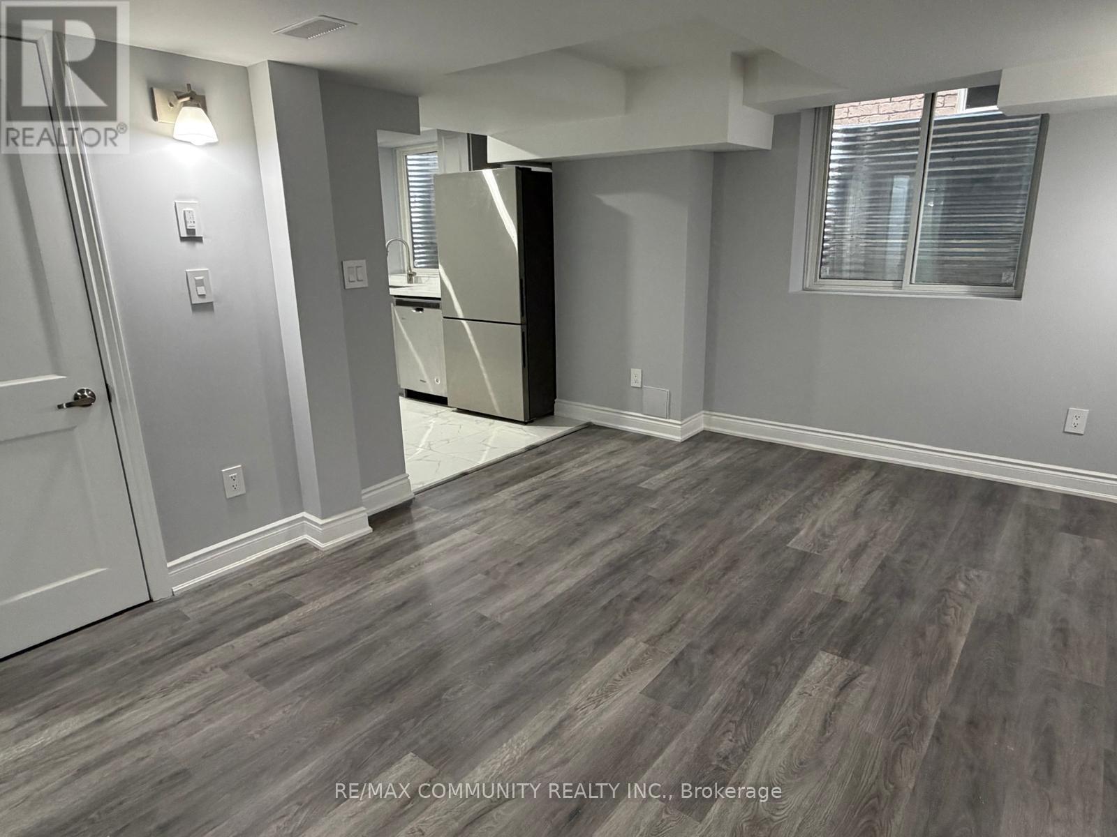 A room with a grey floor and a white door.