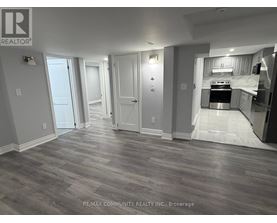 A room with a grey floor and a white door.