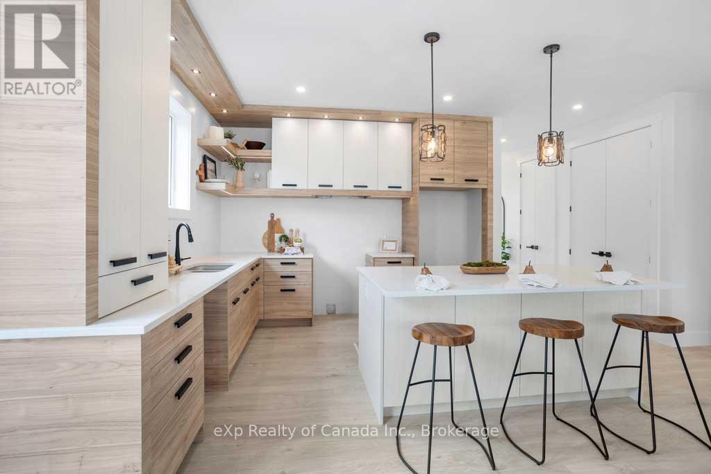 A modern kitchen with wooden cabinets and a white island.