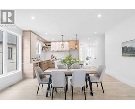 A modern dining room with a table set for four.