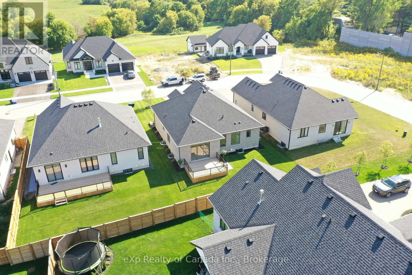 A bird's eye view of a housing development with multiple houses and a playground.