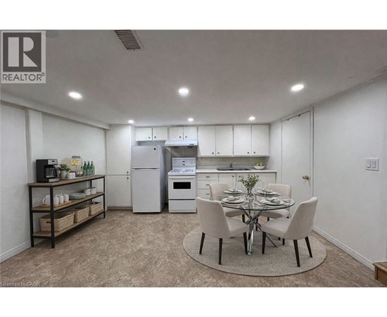 A well-lit kitchen with a dining table set for four.