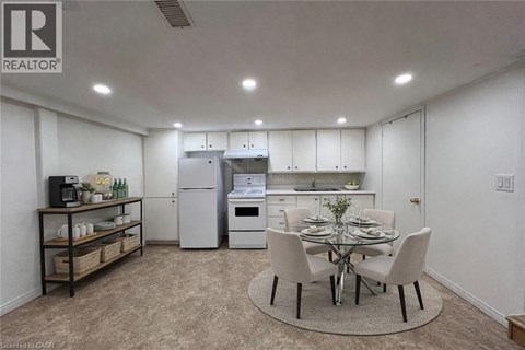 A well-lit kitchen with a dining table set for four.