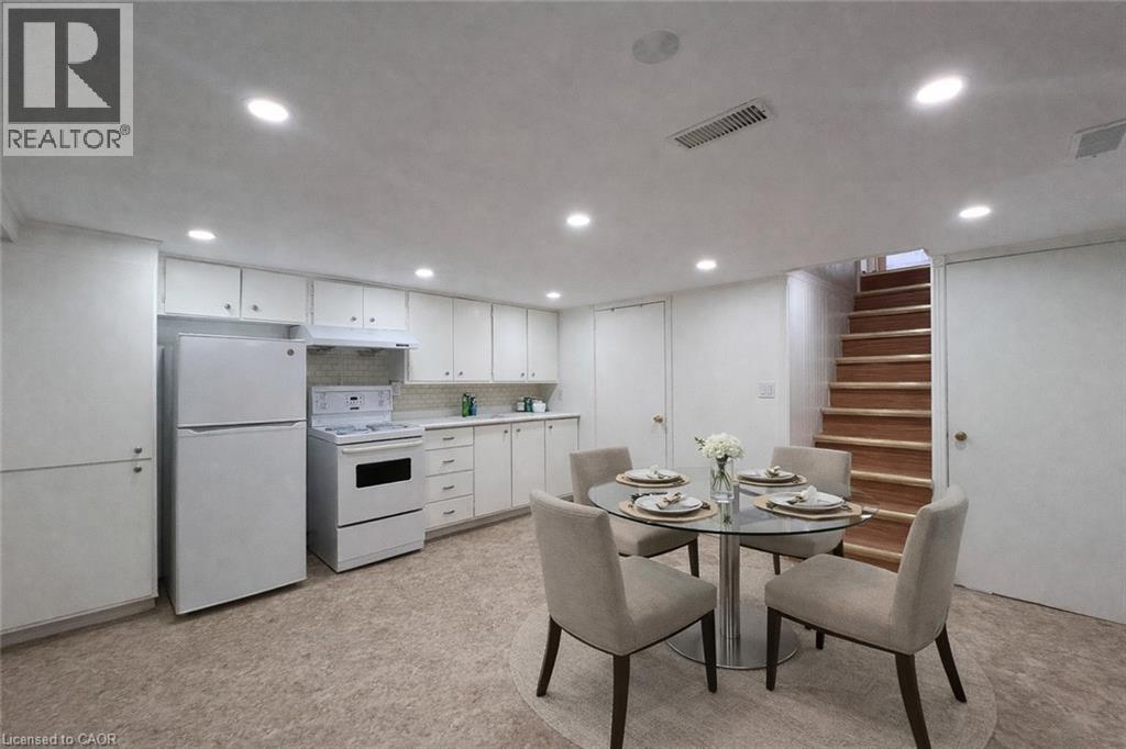 A dining room with a table set for two and a staircase in the background.