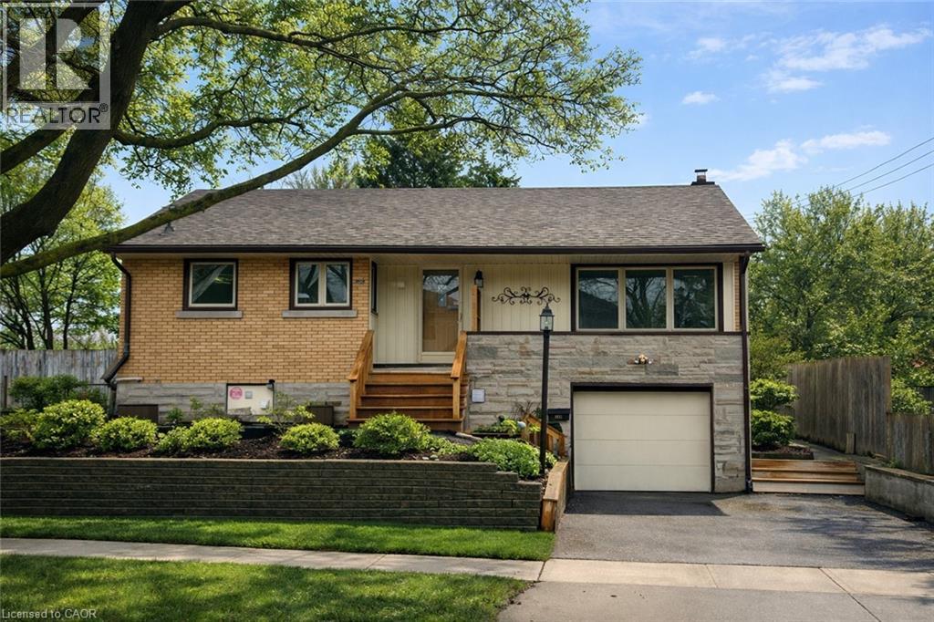 A house with a brown brick exterior and a white garage door.