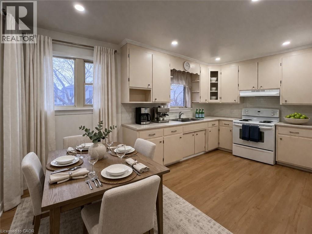 A well-lit kitchen with a dining table set for two.