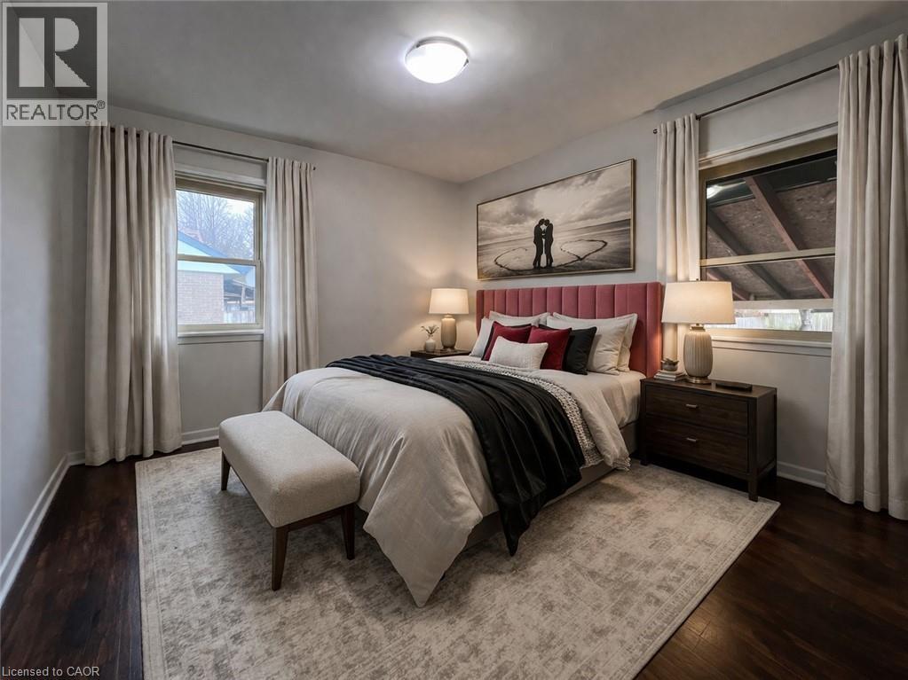 A bedroom with a large bed and a painting on the wall.