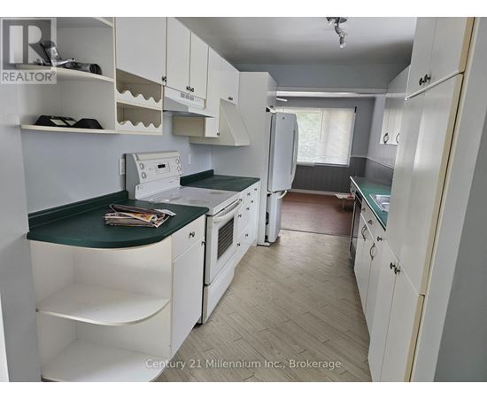 A kitchen with white cabinets and a green countertop.