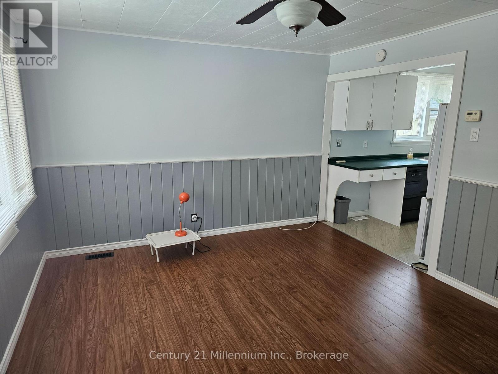 A room with wooden floors and a ceiling fan.