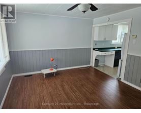 A room with wooden floors and a ceiling fan.