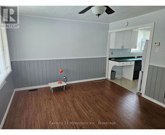 A room with wooden floors and a ceiling fan.