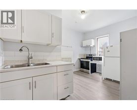 A kitchen with white cabinets and a sink.
