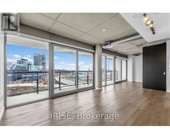 A spacious room with a view of the city through large windows.