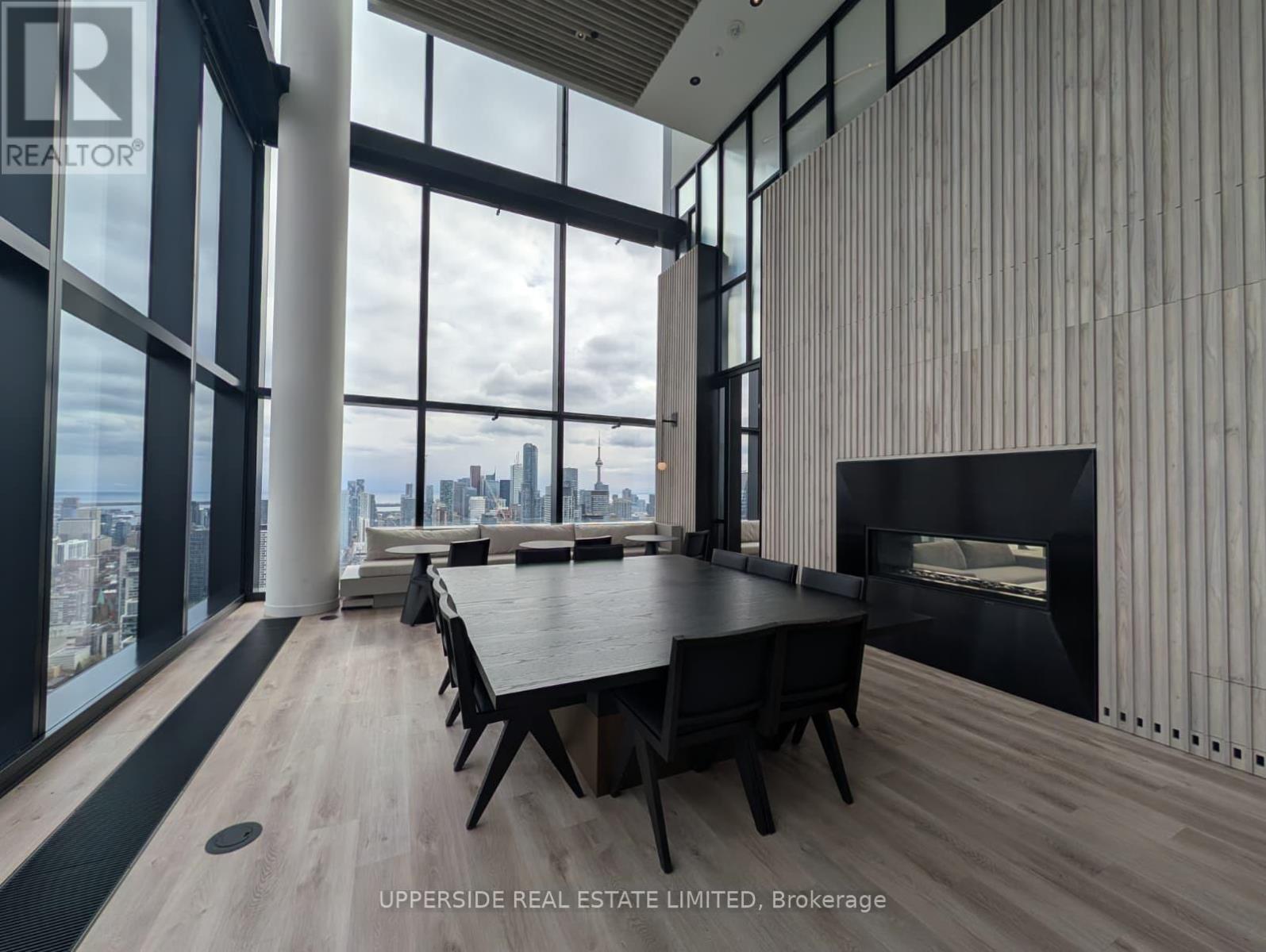 A modern dining room with a view of the cityscape.