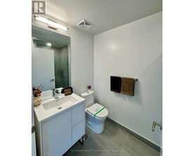 A room with a white door and wooden flooring.
