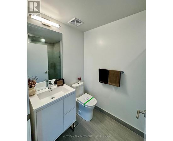 A room with a white door and wooden flooring.