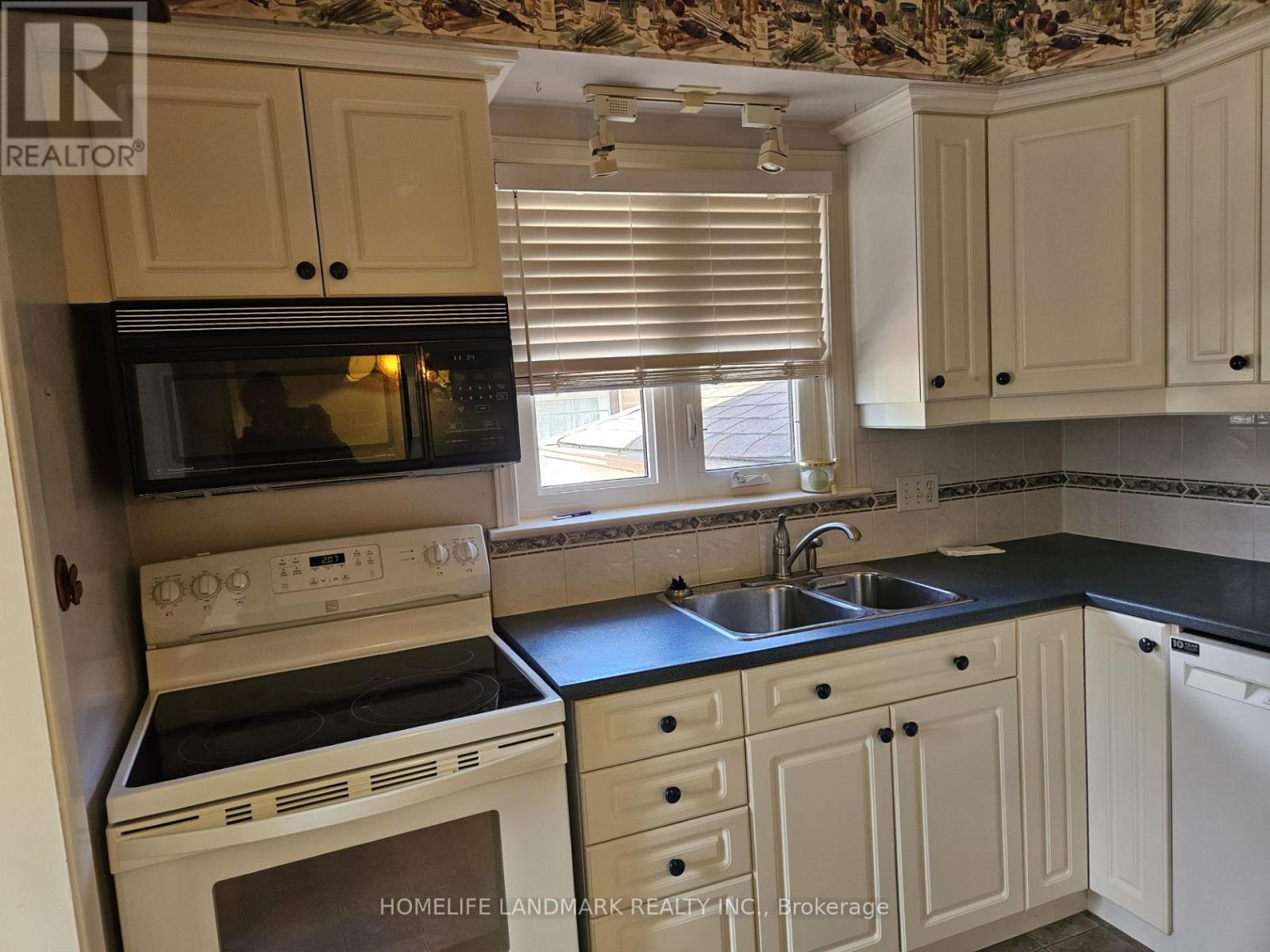 A kitchen with a stove top oven and microwave.
