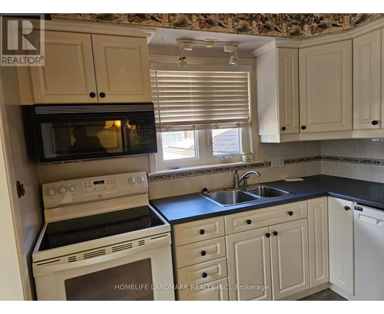 A kitchen with a stove top oven and microwave.