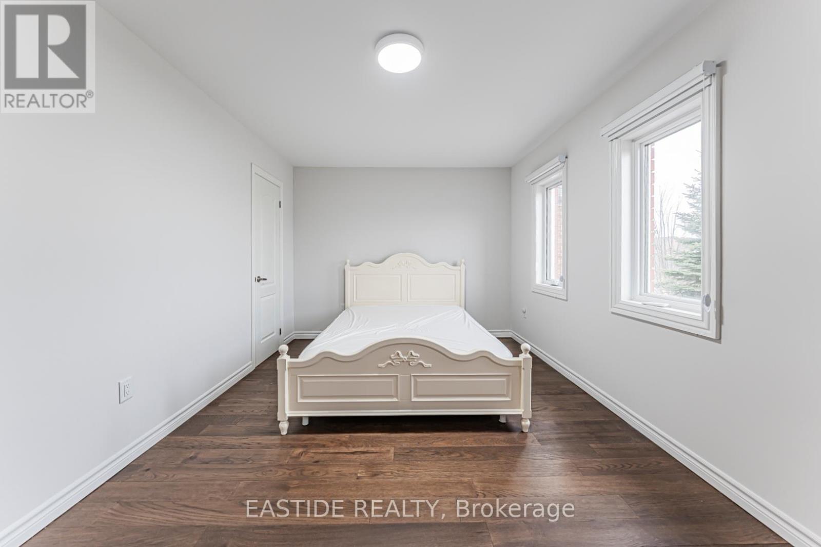 A bedroom with a bed in the middle of the room.