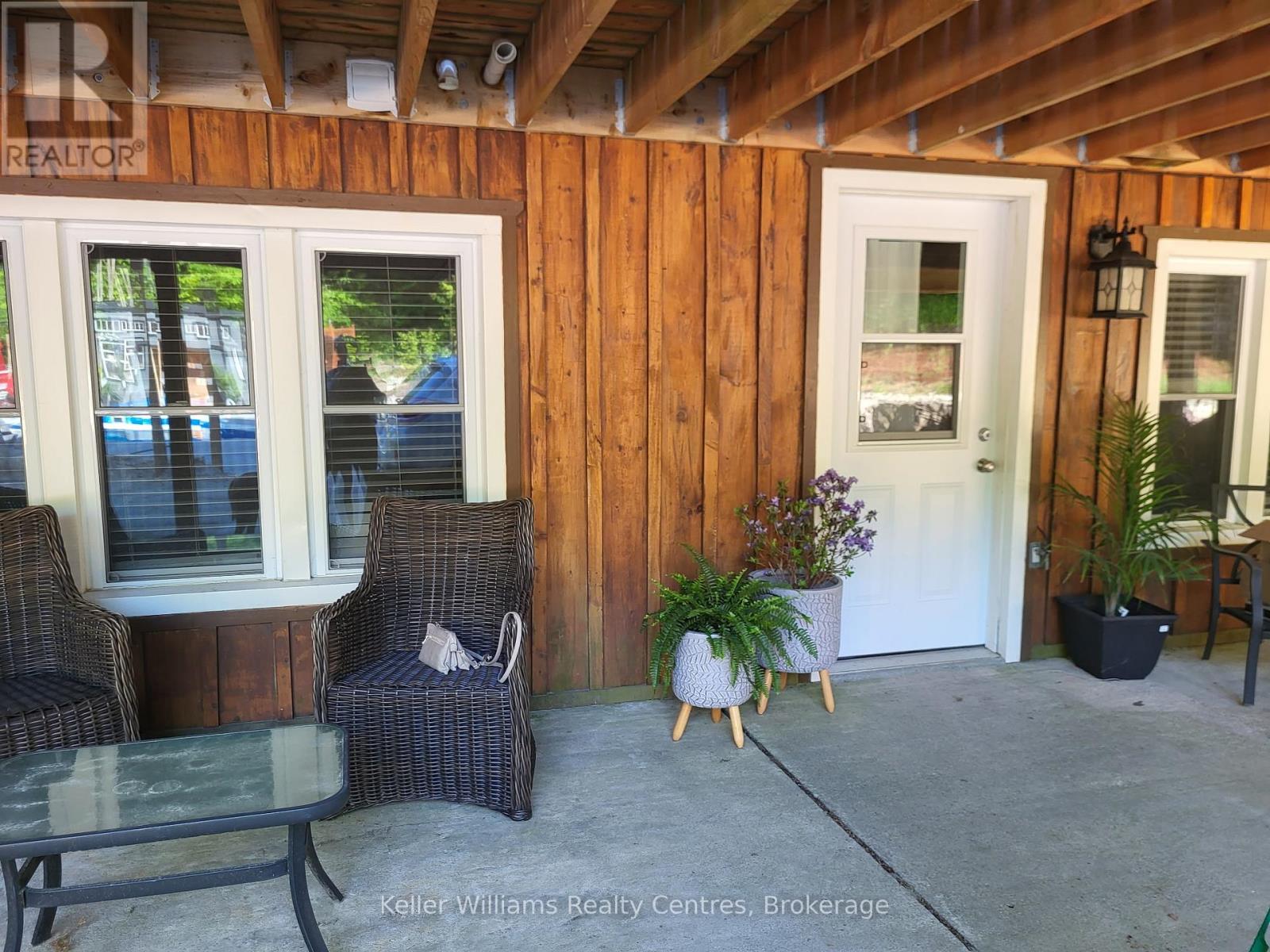 A patio area with a table, chairs, and a door.