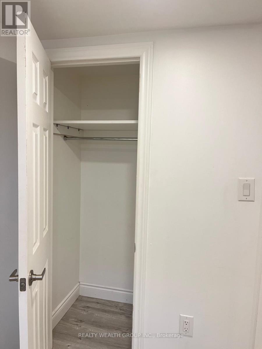 A white door with a handle and a wall with a switch.