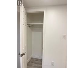 A white door with a handle and a wall with a switch.