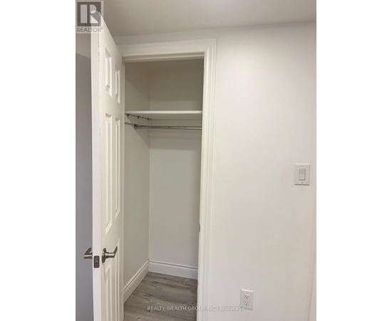 A white door with a handle and a wall with a switch.