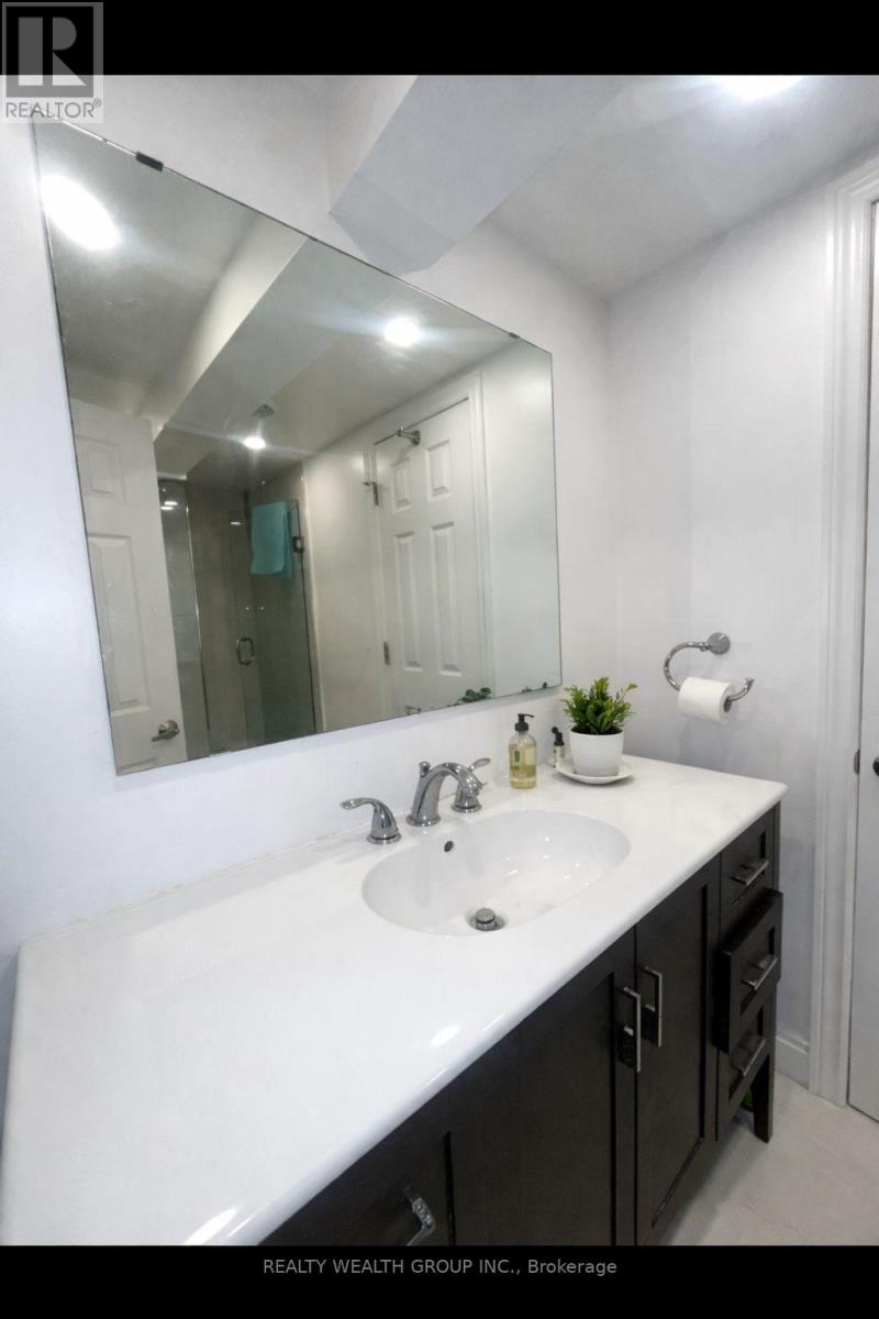 A bathroom with a white sink and a mirror.