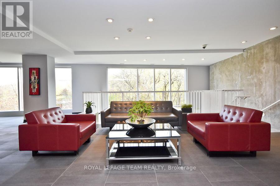 A living room with a red couch and a coffee table.
