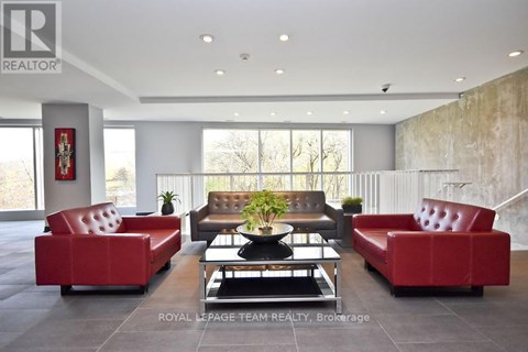 A living room with a red couch and a coffee table.