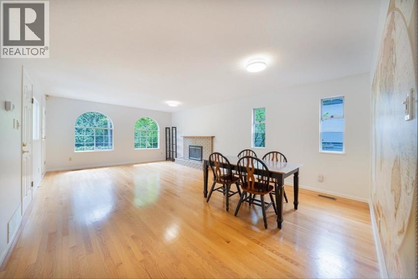 A large room with a table and chairs in it.