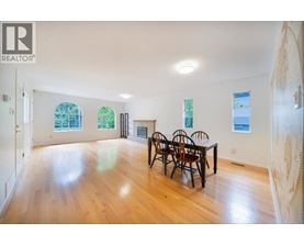 A large room with a table and chairs in it.