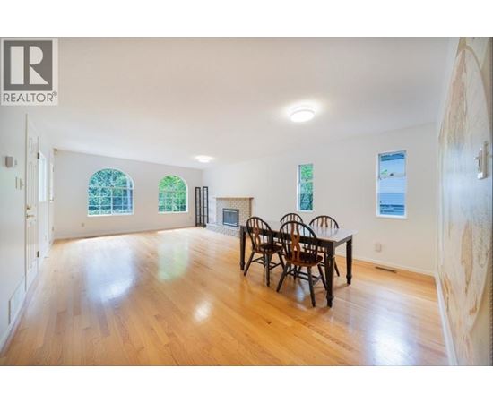 A large room with a table and chairs in it.