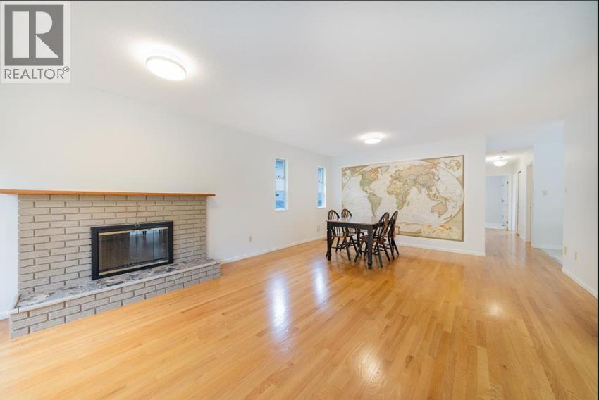 A living room with a fireplace and a large map on the wall.