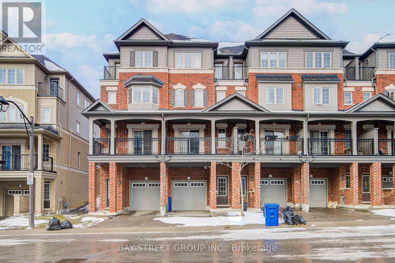 A large, multi-story residential building with a brick facade and multiple balconies.