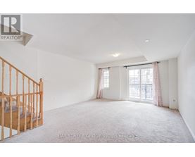 A spacious bedroom with a large bed and a window with curtains.
