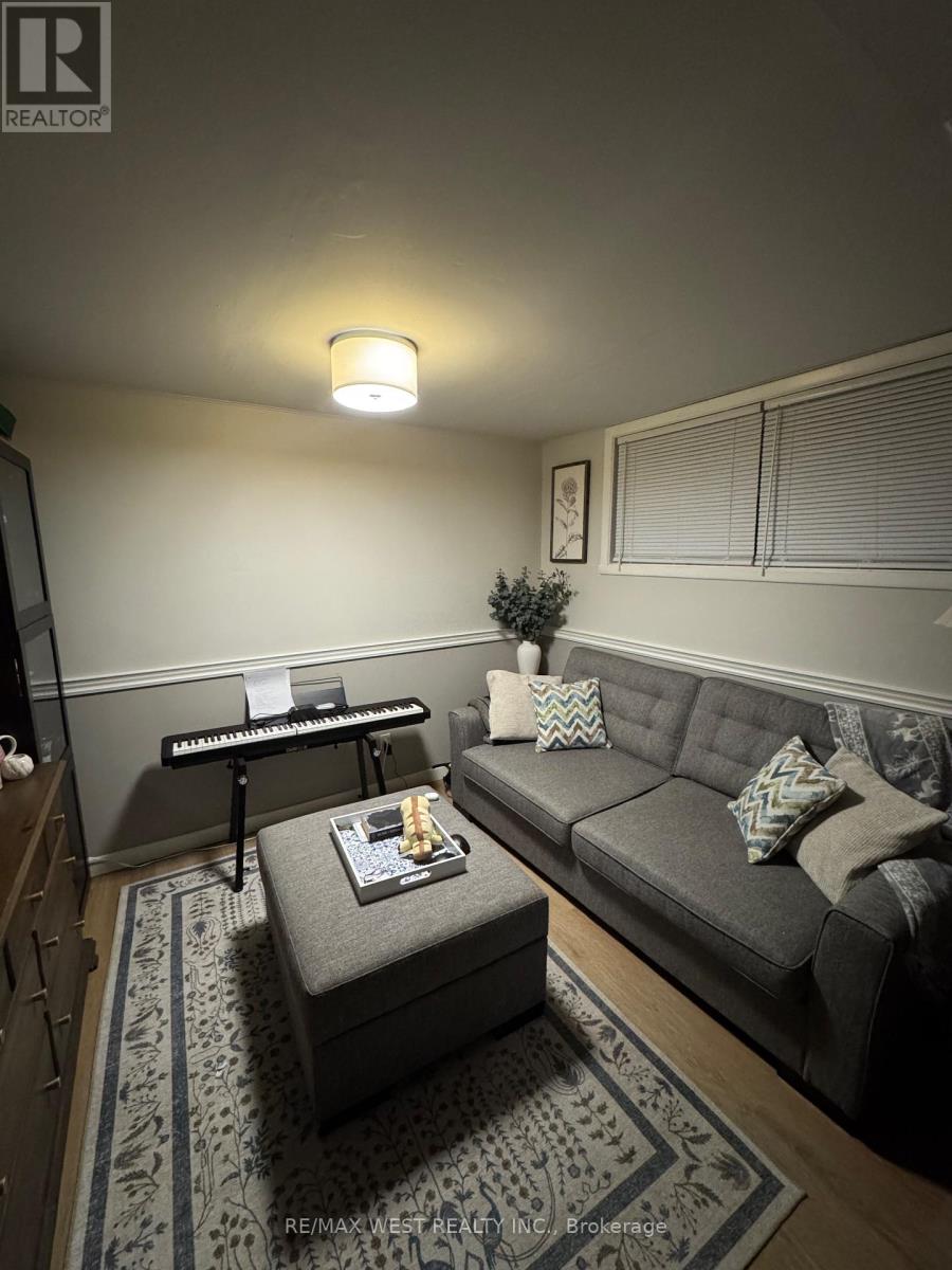 A living room with a grey couch, a coffee table, and a TV.