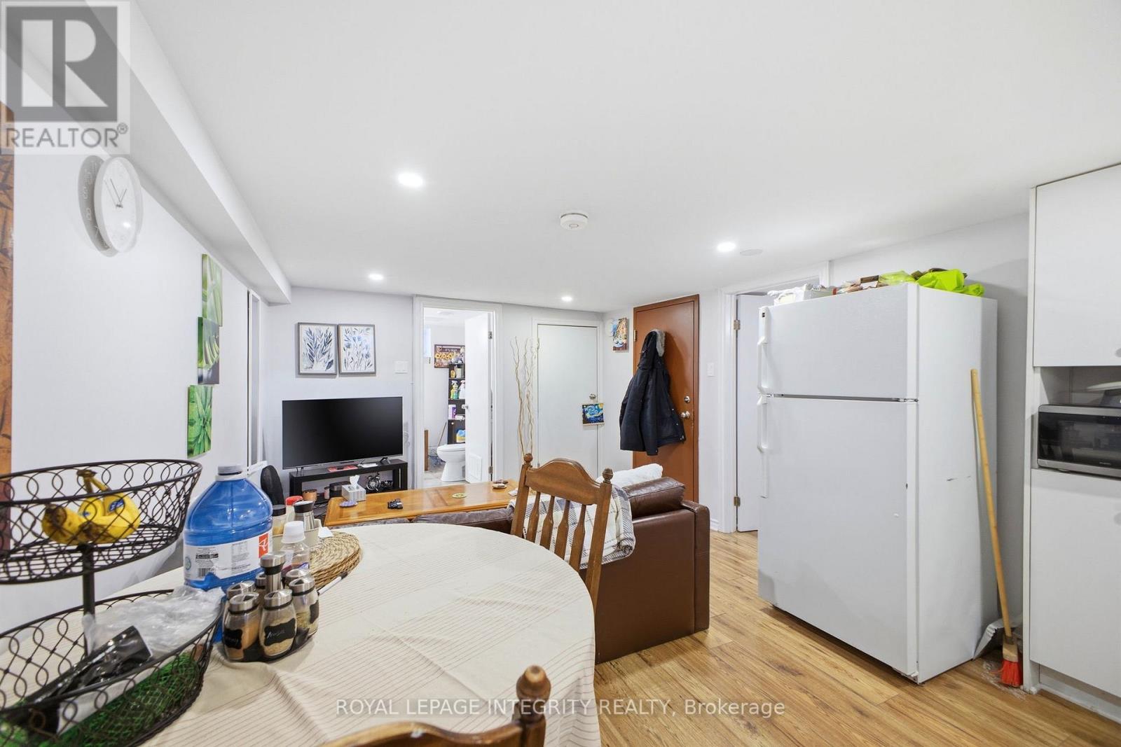 A kitchen with a table and chairs in the middle of the room.