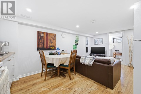 A living room with a dining table and chairs.