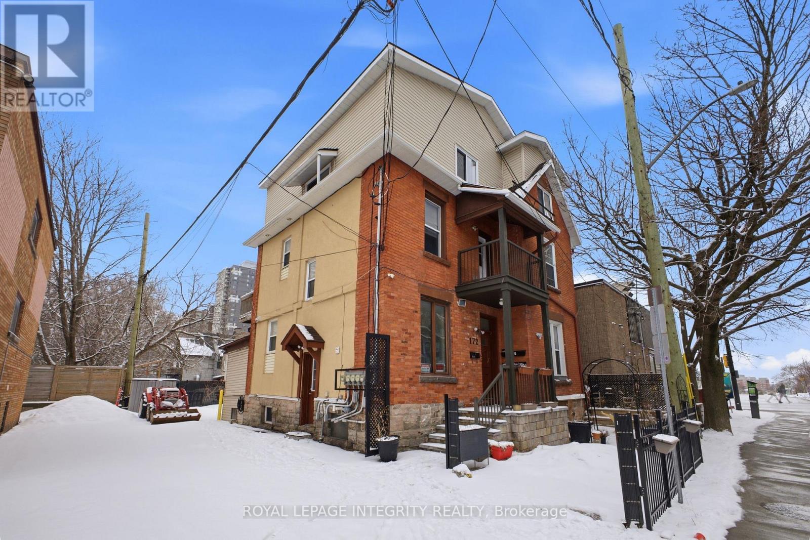 A house with a snow-covered front yard.