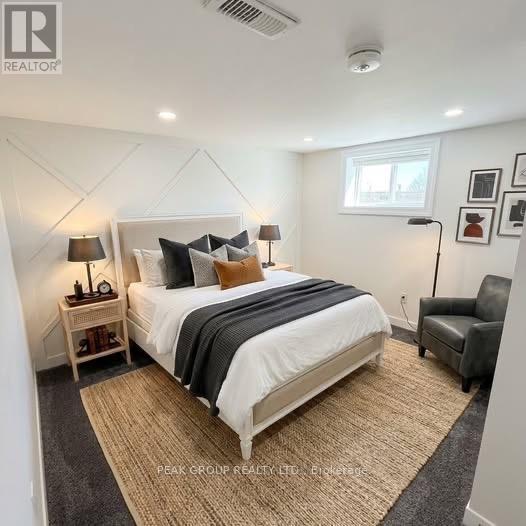 A bedroom with a large bed and a window.