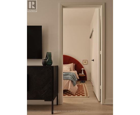 A bedroom with a bed, a chair, and a television.