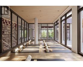 A spacious room with yoga mats and a pillar in the middle.