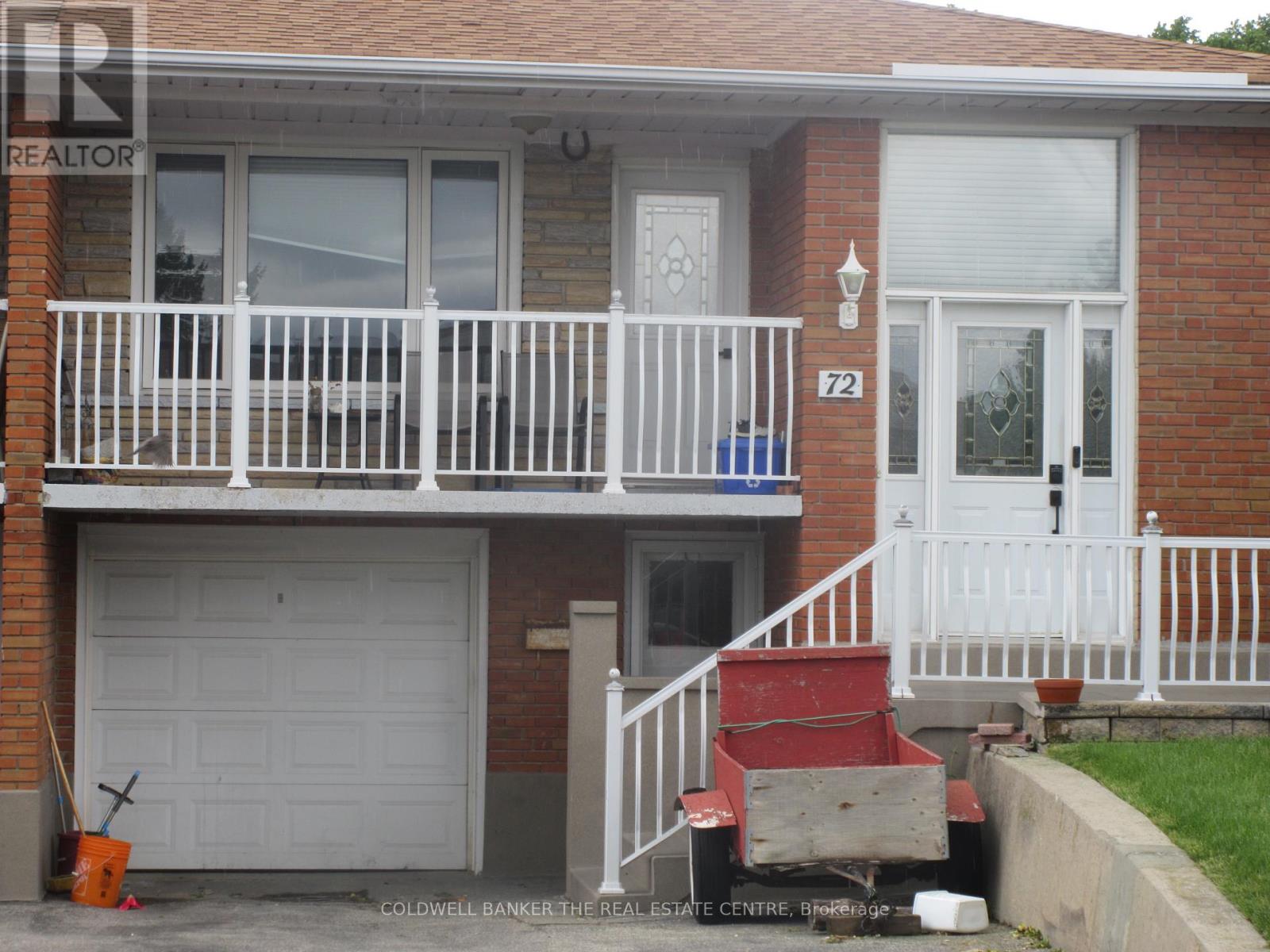 A two-story house with a white front door and a white garage door.