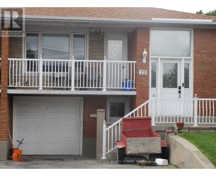 A two-story house with a white front door and a white garage door.