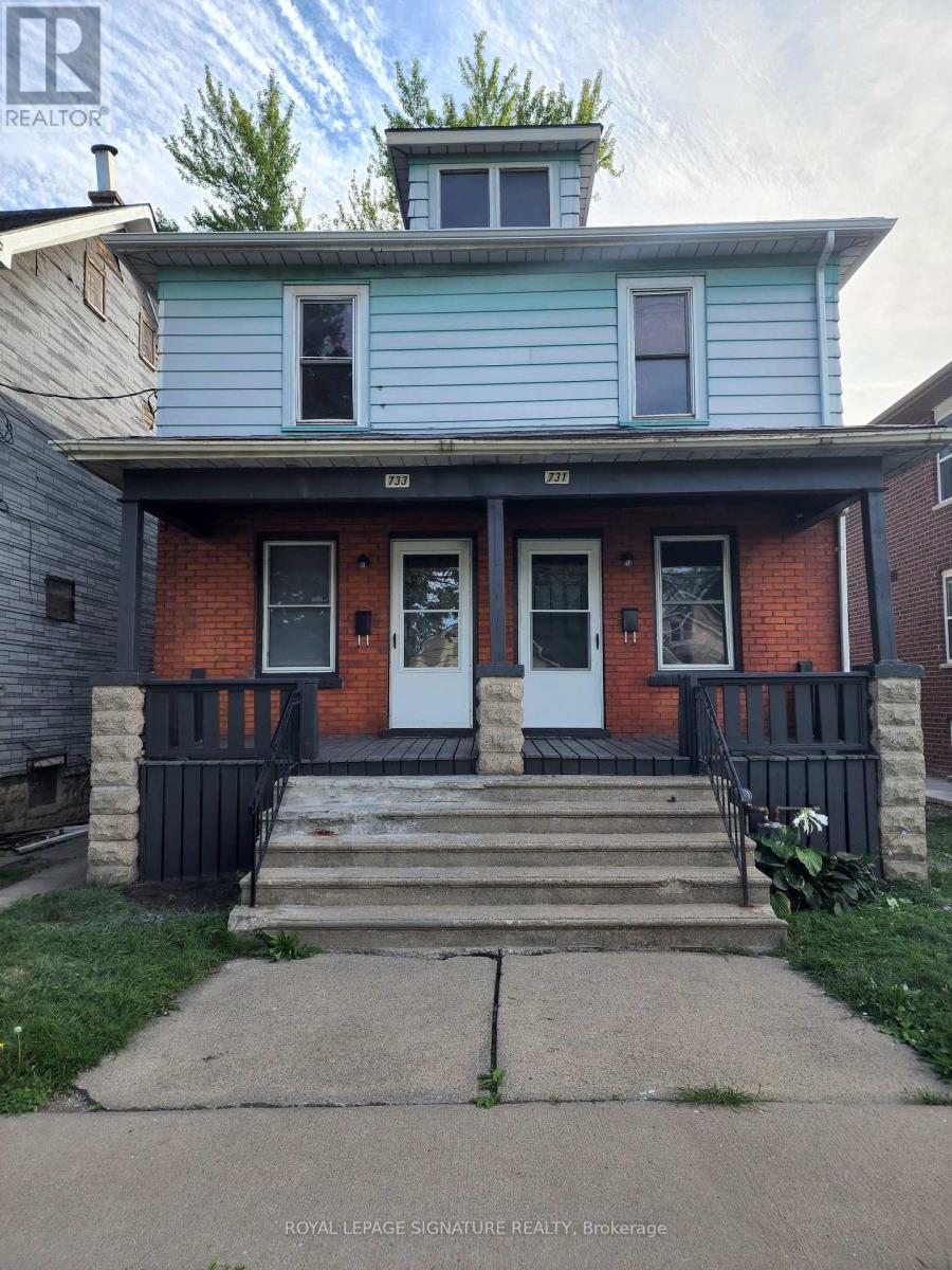 A blue house with a white door and windows.